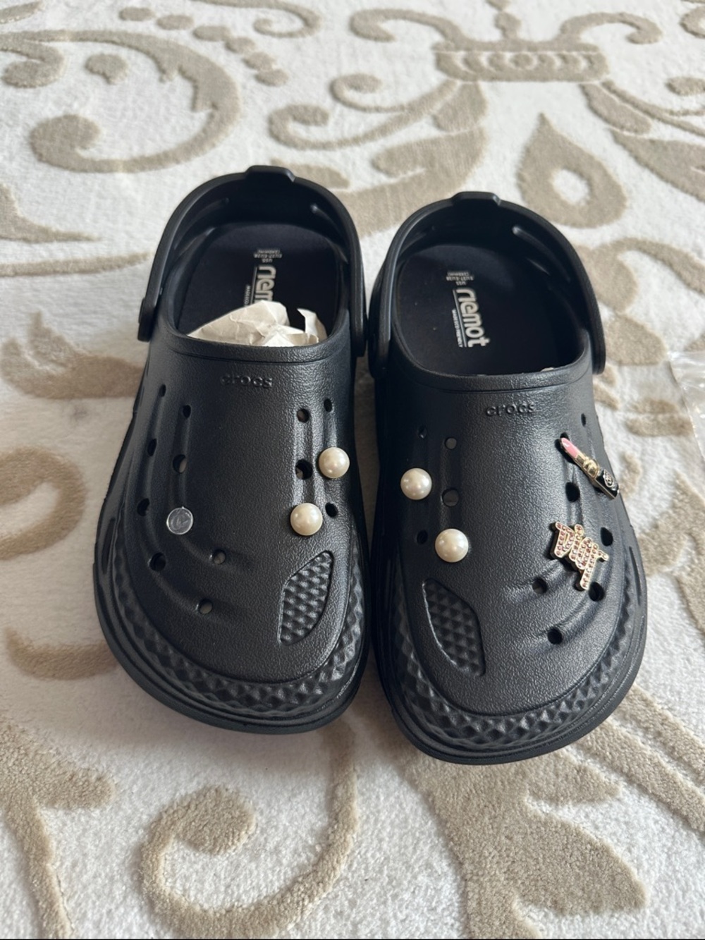 Women’s black Crocs with extra inserts and homemade charms